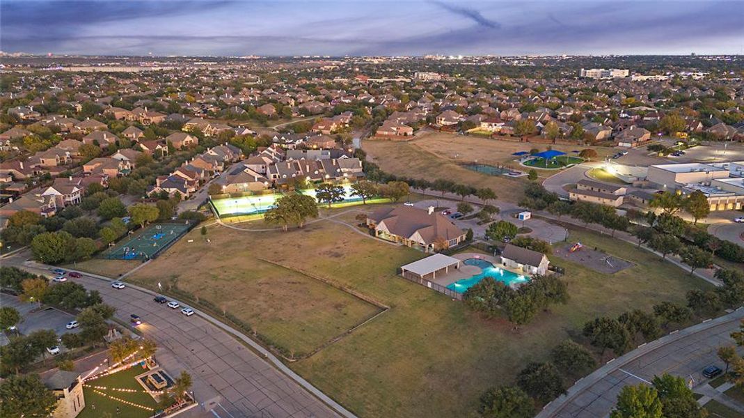 Aerial view at dusk of view of pool area and a residential view