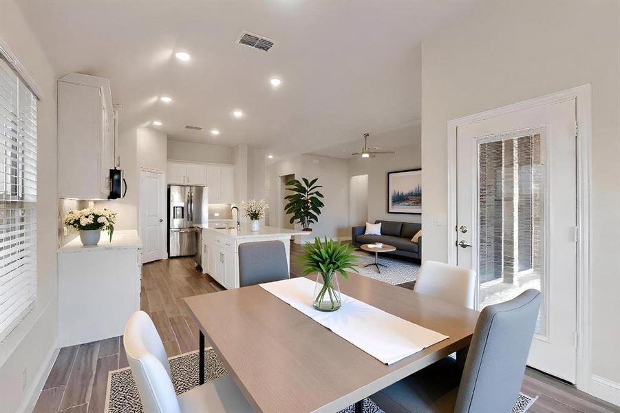 Dining room with wood finish floors, recessed lighting, and a ceiling fan