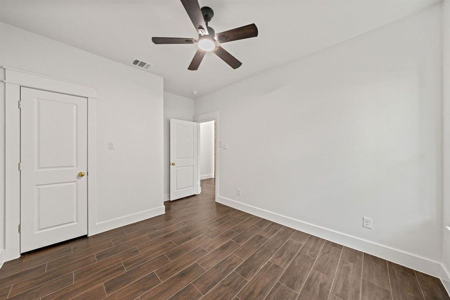 Unfurnished bedroom with wood finish floors and ceiling fan Unfurnished bedroom with wood finish floors and ceiling fan