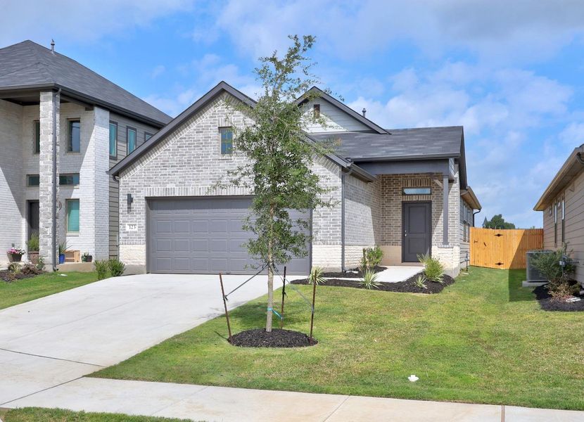 Front exterior of a new home in Trinity Ranch, Elgin, TX, highlighting curb appeal (Image 2). Front exterior of a new home in Trinity Ranch, Elgin, TX, highlighting curb appeal (Image 2).