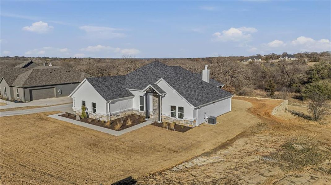 Front exterior of a new home in , Springtown, TX, highlighting curb appeal (Image 15).