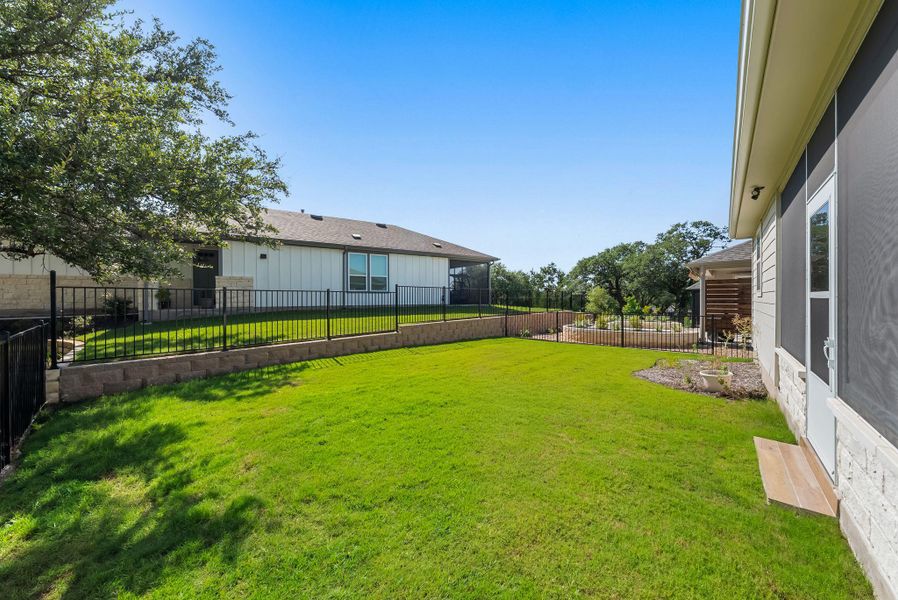 A vibrant green lawn and well-maintained fencing enhance this inviting backyard space. A vibrant green lawn and well-maintained fencing enhance this inviting backyard space.