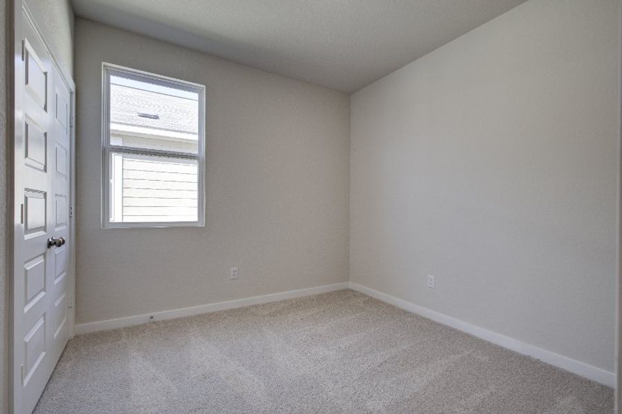 A room with white walls and a window.