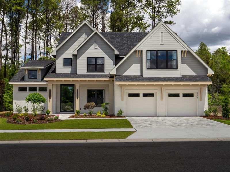 Front exterior of a new home in Laureate Village, Newberry, FL, highlighting curb appeal (Image 1). Front exterior of a new home in Laureate Village, Newberry, FL, highlighting curb appeal (Image 1).