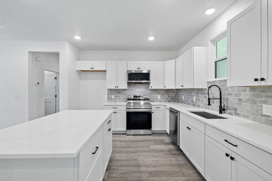 Culinary dreams come alive in this well-appointed kitchen featuring a large island and ample counter space. Culinary dreams come alive in this well-appointed kitchen featuring a large island and ample counter space.
