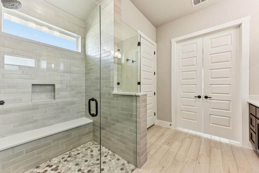 Full bath featuring a stall shower, light wood finished floors, and vanity