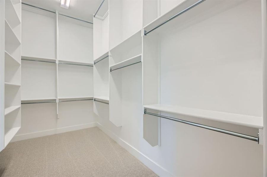 Walk in closet with light colored carpet Walk in closet with light colored carpet