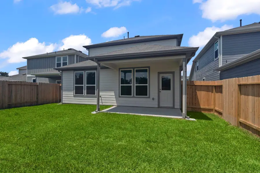 Front exterior of a new home in Peppervine, Porter, TX, highlighting curb appeal (Image 1).