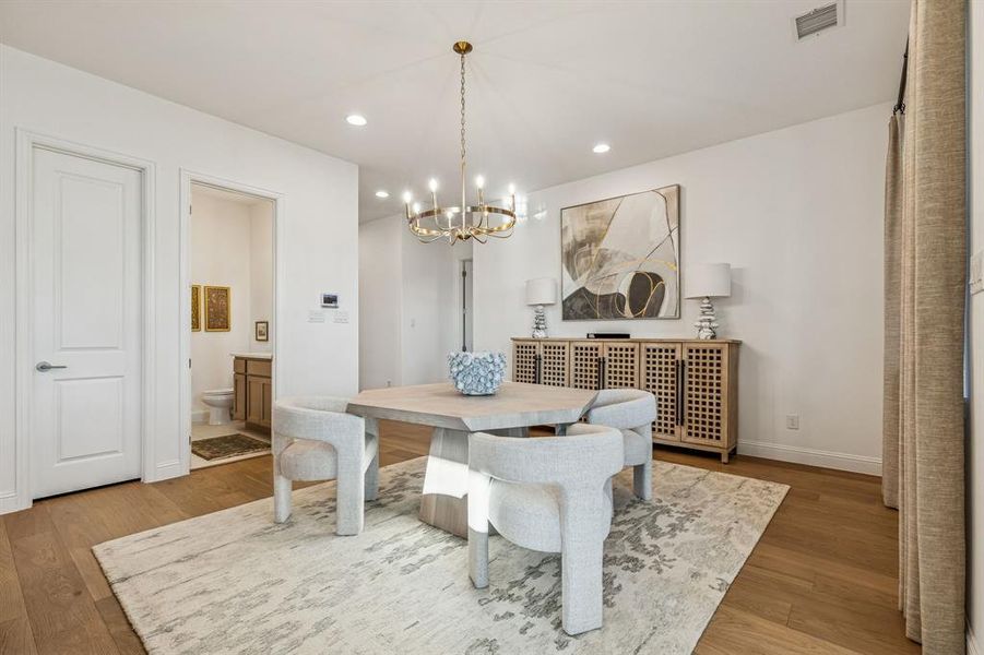 Dining area featuring light wood-style floors and a chandelier