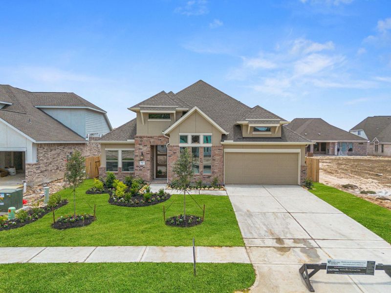 Front exterior of a new home in The Meadows at Imperial Oaks 60', Conroe, TX, highlighting curb appeal (Image 20). Front exterior of a new home in The Meadows at Imperial Oaks 60', Conroe, TX, highlighting curb appeal (Image 20).
