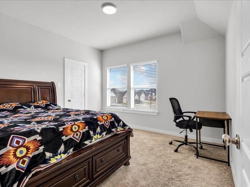 Bedroom featuring light colored carpet