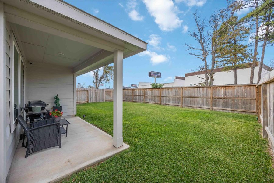 Charming backyard with a covered patio.