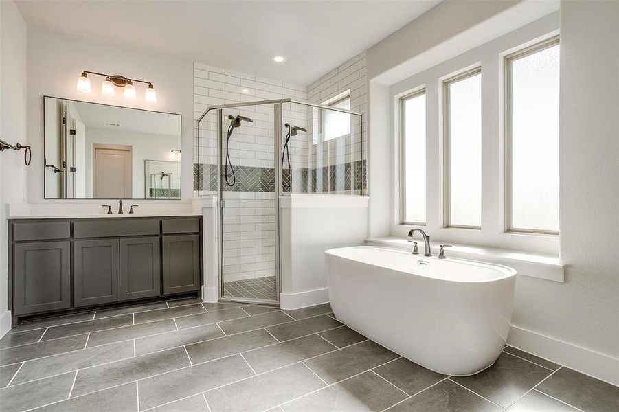 Bathroom featuring vanity, independent shower and bath, and tile patterned floors