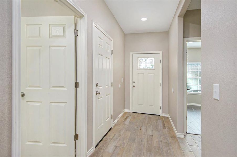 Doorway to outside featuring light wood-style floors and baseboards