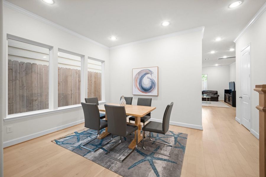 A proper formal dining room with crown molding, engineered wood floors, and enough space for a full dinner party — separated from the kitchen just enough to feel intentional. A proper formal dining room with crown molding, engineered wood floors, and enough space for a full dinner party — separated from the kitchen just enough to feel intentional.