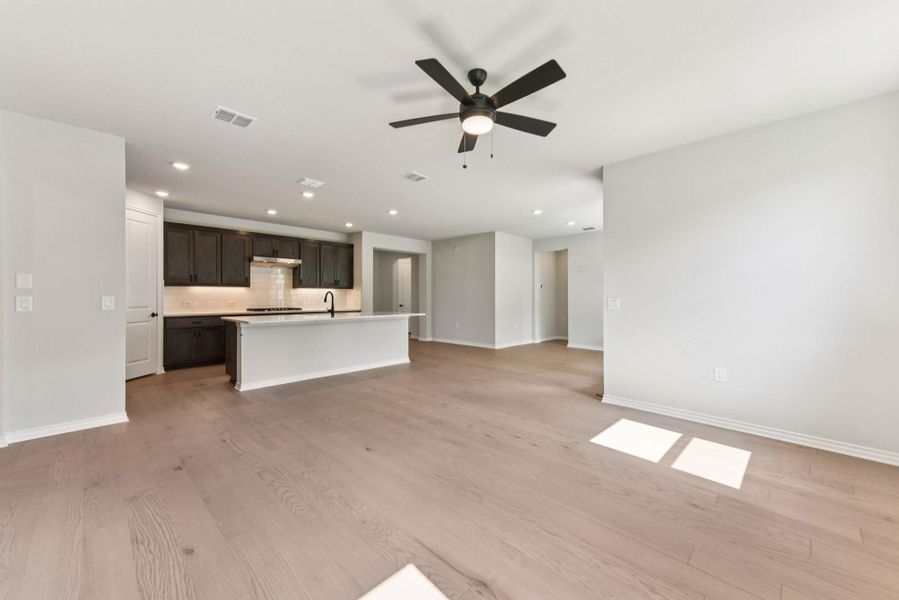Unfurnished living room with light wood-style flooring, recessed lighting, and ceiling fan