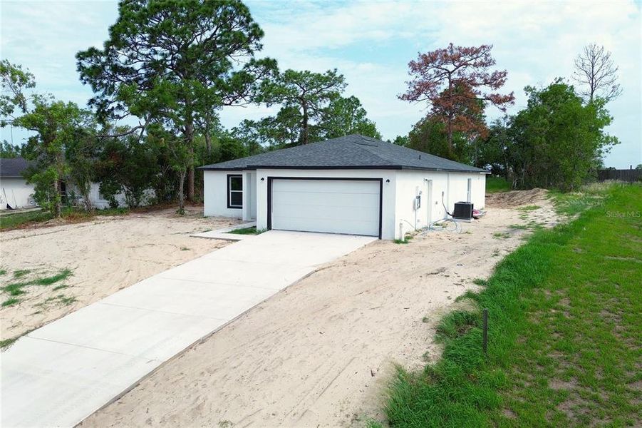 Front exterior of a new home in , Spring Hill, FL, highlighting curb appeal (Image 25).