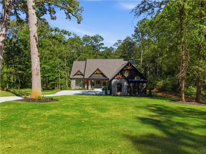 Mature trees frame a manicured lawn leading toward