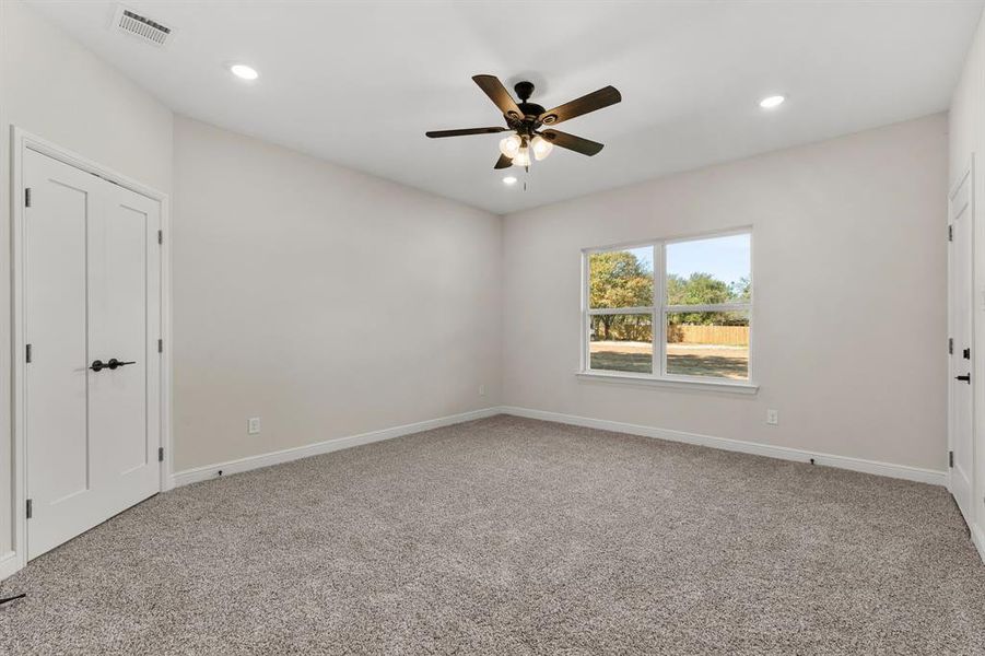 Unfurnished bedroom with light carpet, recessed lighting, and ceiling fan