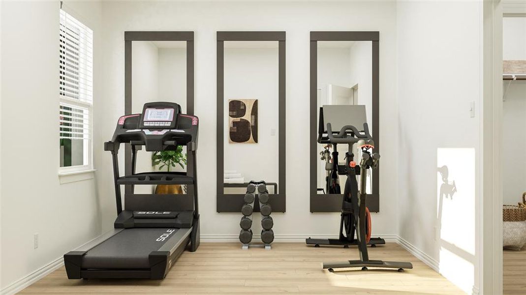 Exercise room featuring light hardwood / wood-style floors