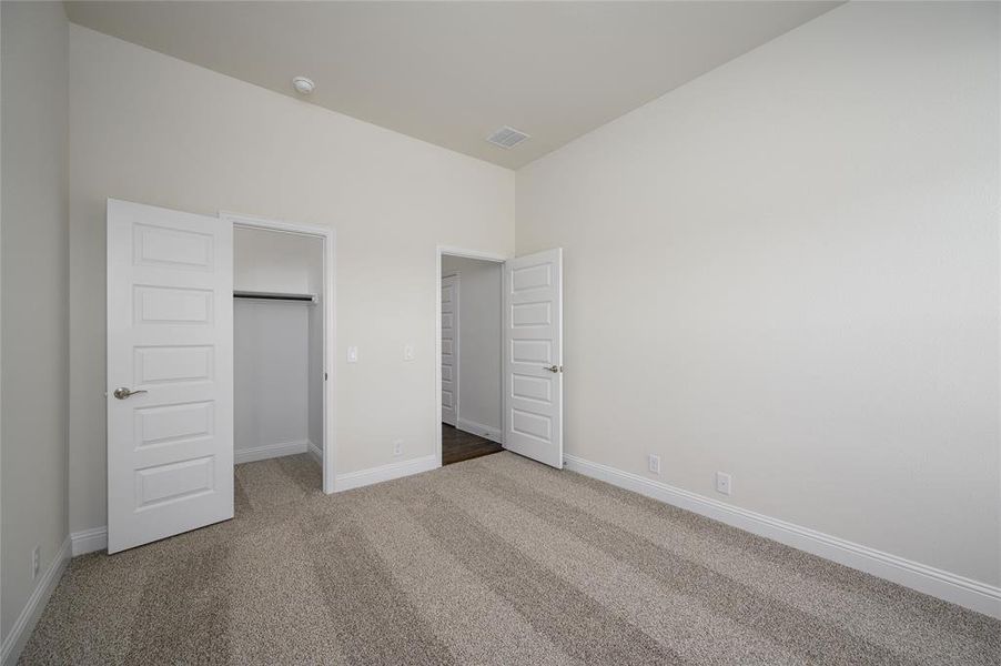 Unfurnished bedroom featuring carpet floors and a closet