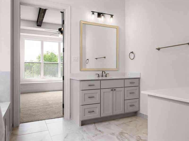 Full bathroom featuring vanity, a ceiling fan, and a tub