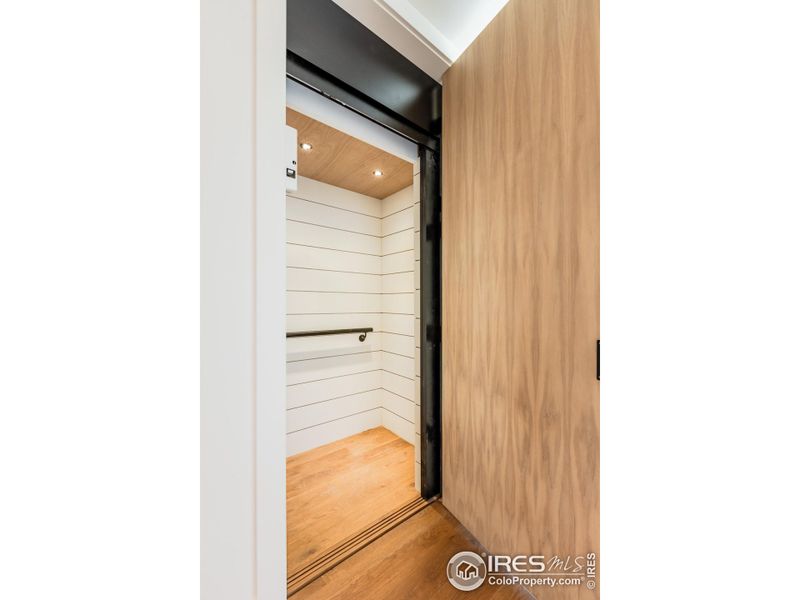 An elevator connects the main level with the two upper levels of the home, providing convenient modern living.