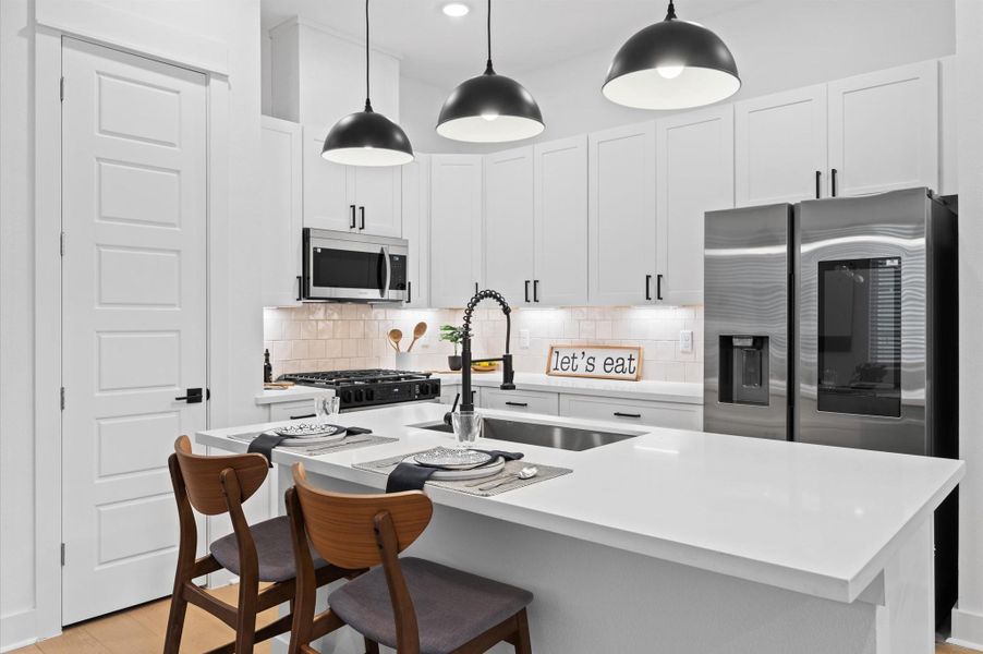 This attractive Kitchen is full of beautiful details. Quartz Countertops, Stainless steel Sink, Stainless Steel Appliances, Recessed Lighting, Undercabinet Lighting, Elegant Cabinetry with Soft Close Drawers and Doors