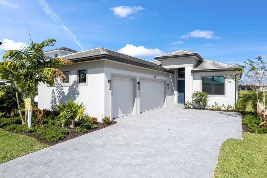 Front exterior of a new home in Cresswind Palm Beach at Westlake, Westlake, FL, highlighting curb appeal (Image 21).