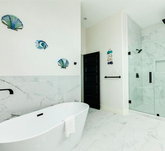 Soaking tub & large walk-in shower in the primary bathroom