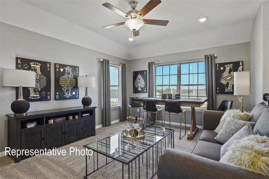 Living space featuring a tray ceiling with a ceiling fan, recessed lighting, and carpet flooring