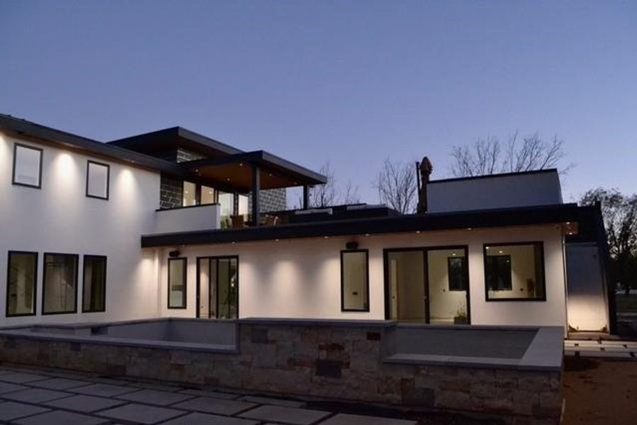 Rear view of property featuring stucco siding, a patio, and a balcony Rear view of property featuring stucco siding, a patio, and a balcony