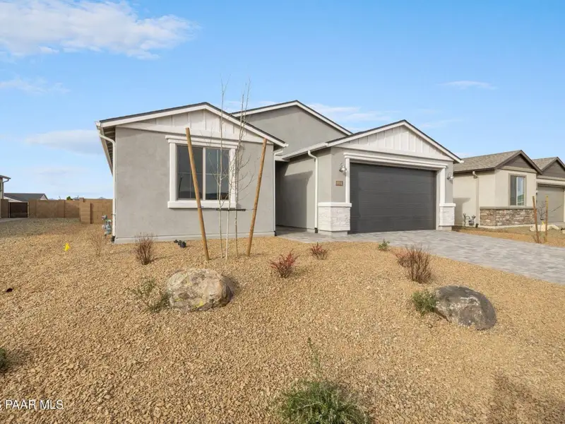 Front exterior of a new home in North Ridge at Pronghorn Ranch, Prescott Valley, AZ, highlighting curb appeal (Image 2). Front exterior of a new home in North Ridge at Pronghorn Ranch, Prescott Valley, AZ, highlighting curb appeal (Image 2).