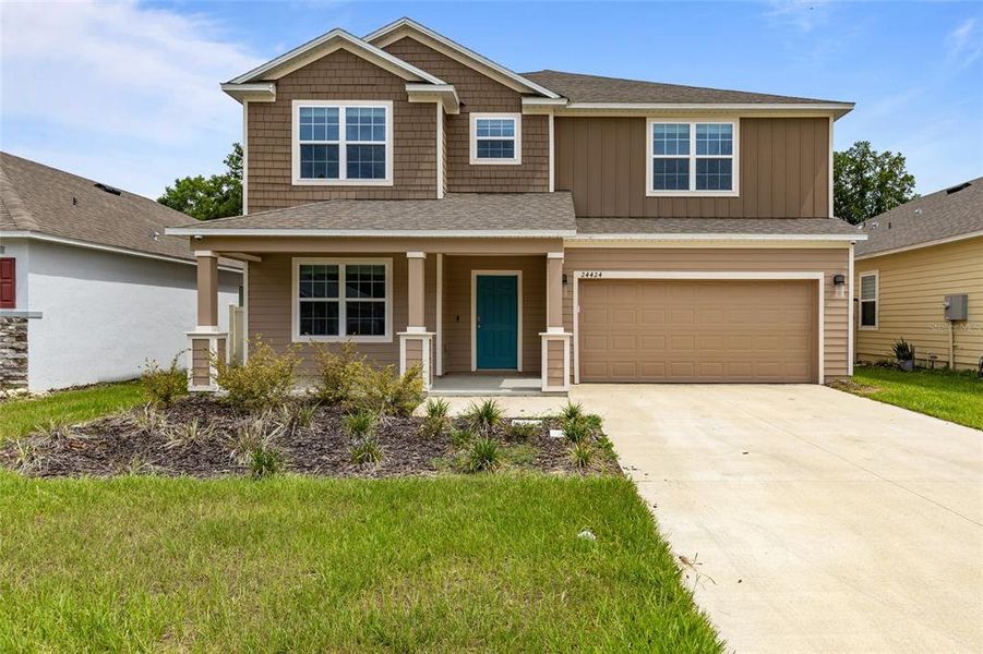 Front exterior of a new home in Avalon Woods, Newberry, FL, highlighting curb appeal (Image 22).