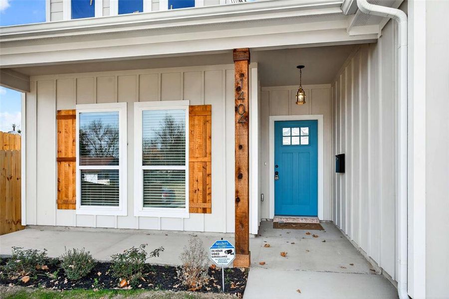 Entrance to property featuring board and batten siding and a porch