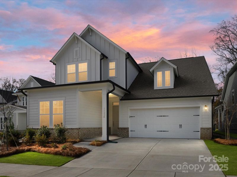 Front exterior of a new home in North Creek Village, Huntersville, NC, highlighting curb appeal (Image 1).