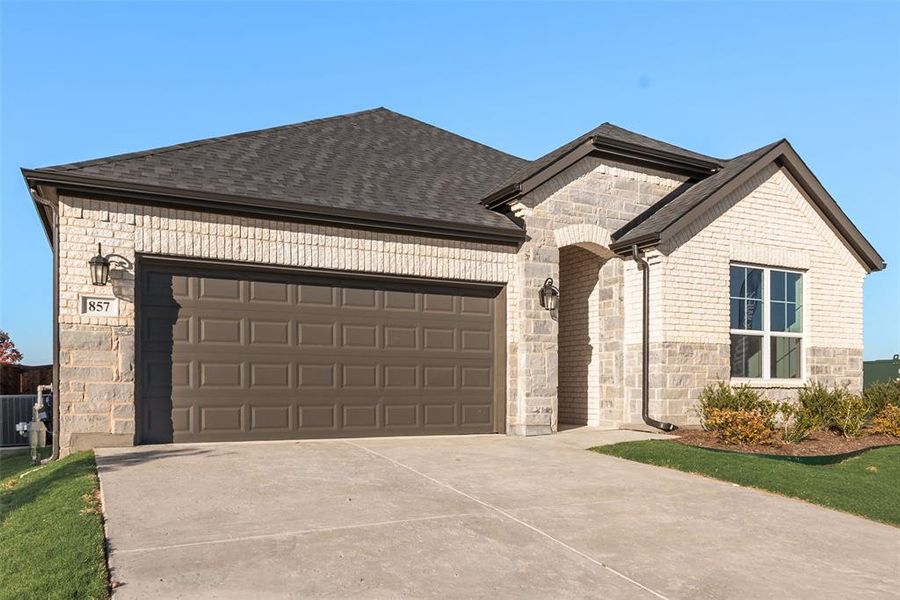 Front exterior of a new home in Wildflower Ranch, Justin, TX, highlighting curb appeal (Image 2). Front exterior of a new home in Wildflower Ranch, Justin, TX, highlighting curb appeal (Image 2).