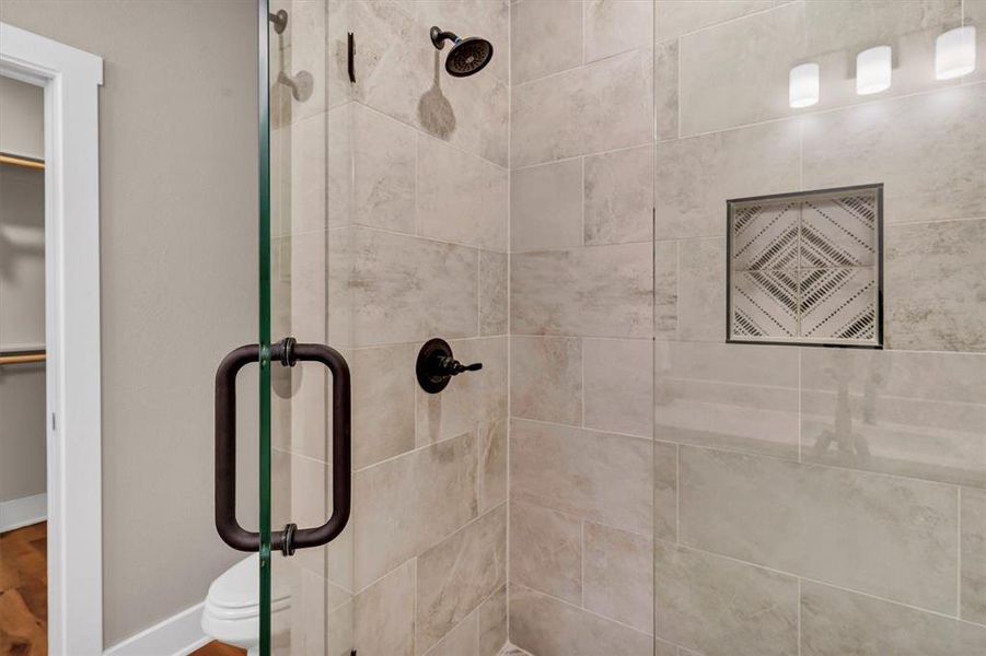 Full bath featuring a stall shower and a spacious closet Full bath featuring a stall shower and a spacious closet
