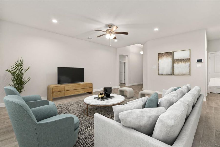 Living room featuring ceiling fan and light hardwood / wood-style floors