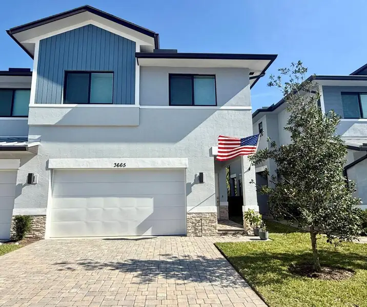 Front exterior of a new home in , Palm City, FL, highlighting curb appeal (Image 1). Front exterior of a new home in , Palm City, FL, highlighting curb appeal (Image 1).