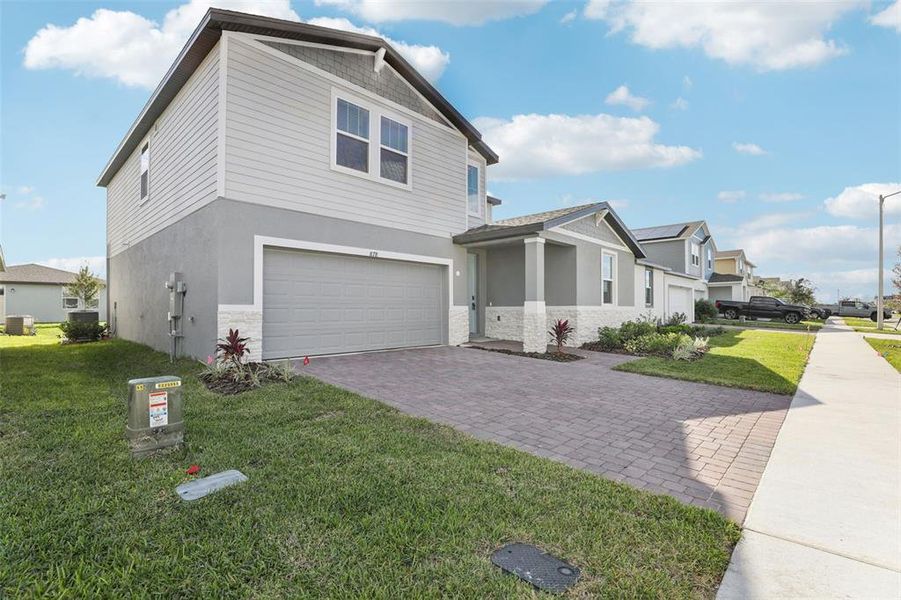 Front exterior of a new home in Lawson Dunes - Signature Series, Haines City, FL, highlighting curb appeal (Image 25).