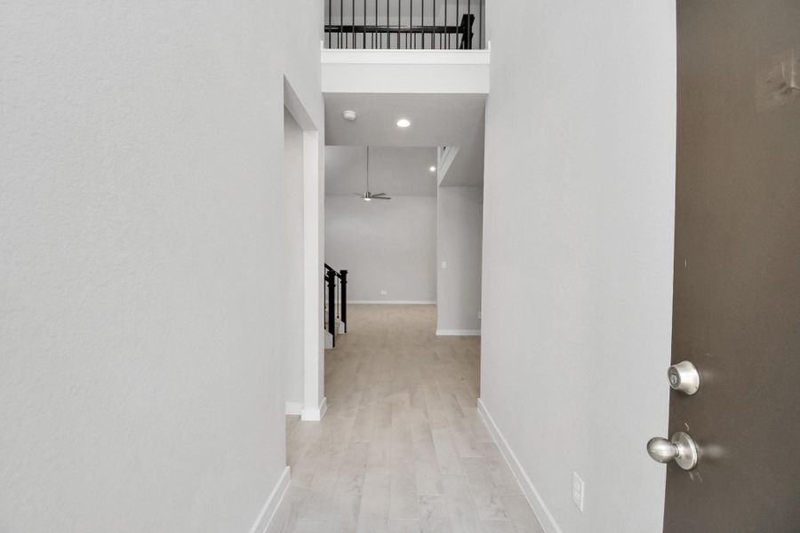 As you step into the threshold of this luxurious home, you'll soon be welcomed by an elegant glass door (to be installed). Inside, soaring ceilings amplify the spaciousness, while the refined wood-look tile flooring and oversized baseboards exude sophistication and charm. Sample photo of completed home with similar floor plan. Actual colors and selections may vary. As you step into the threshold of this luxurious home, you'll soon be welcomed by an elegant glass door (to be installed). Inside, soaring ceilings amplify the spaciousness, while the refined wood-look tile flooring and oversized baseboards exude sophistication and charm. Sample photo of completed home with similar floor plan. Actual colors and selections may vary.