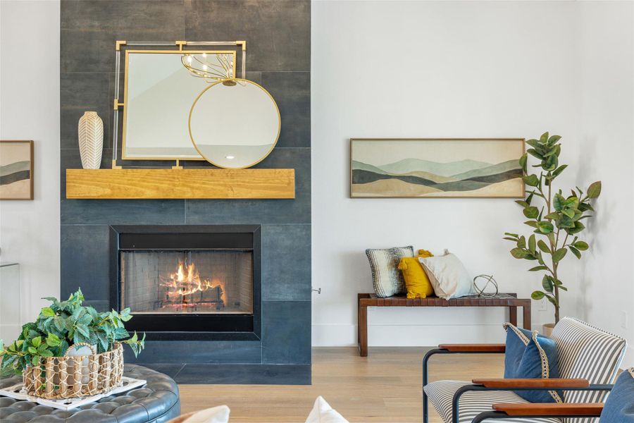 Detailed view of wood finished floors and a warm lit fireplace