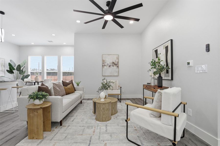 Bright living area featuring wood-finish flooring, recessed lighting, and a modern ceiling fan