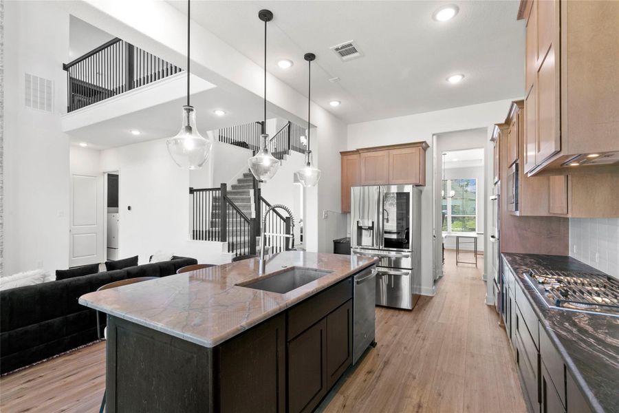 Beautiful kitchen leading into butler's pantry open to family room