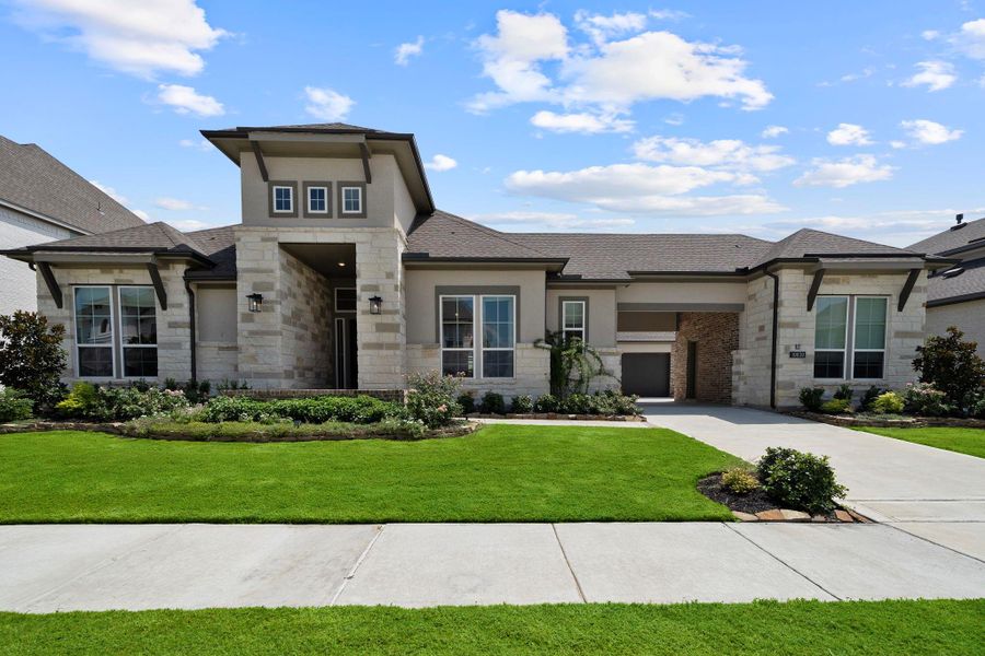 Boasting a beautiful stone and brick exterior, the home features a spacious driveway with ample parking space. Boasting a beautiful stone and brick exterior, the home features a spacious driveway with ample parking space.