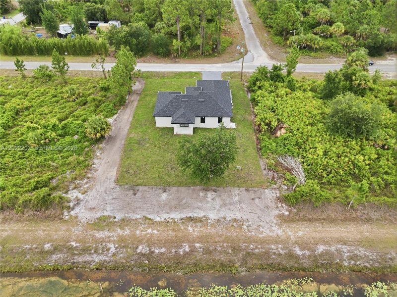 Front exterior of a new home in , Lehigh Acres, FL, highlighting curb appeal (Image 18).
