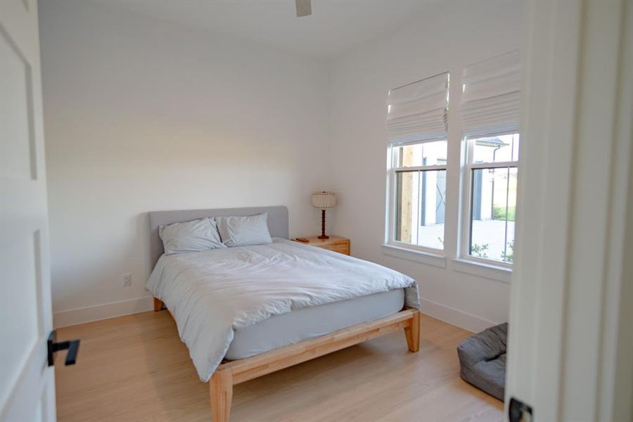 Bedroom with wood finished floors and ceiling fan Bedroom with wood finished floors and ceiling fan