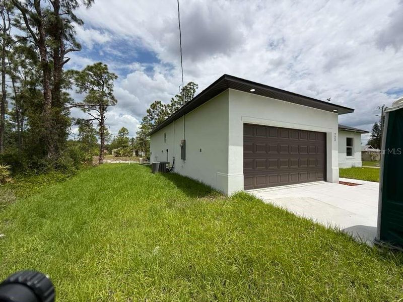 Front exterior of a new home in , Lehigh Acres, FL, highlighting curb appeal (Image 18). Front exterior of a new home in , Lehigh Acres, FL, highlighting curb appeal (Image 18).