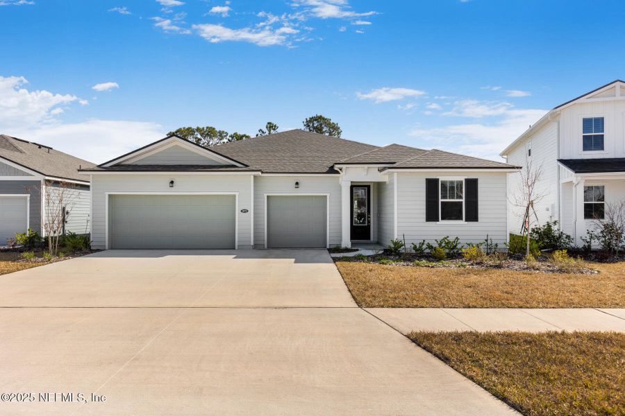 Front exterior of a new home in Lakes at Bella Lago, Green Cove Springs, FL, highlighting curb appeal (Image 1).